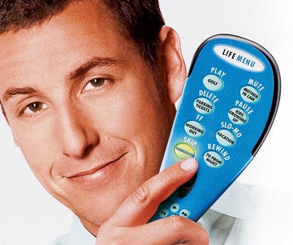 Adam Sandler holding a TV remote labeled “LIFE MENU.” From the movie poster for “Click”