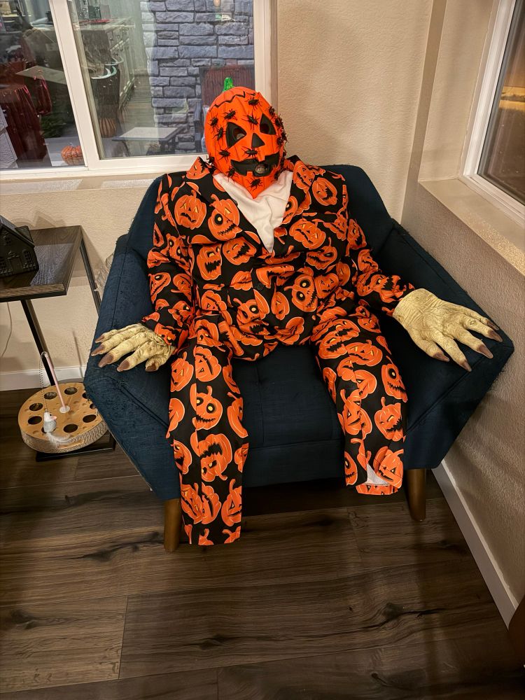 A creature in a pumpkins sure with a pumpkin mask on