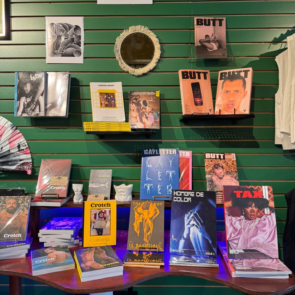 Wall display of queer literature and magazines