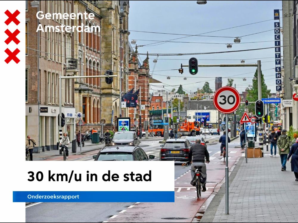 People of all ages and abilities walk, cycle, and drive along the low-traffic streets of Amsterdam, which are lined with buildings, trees, bike infrastructure, and prominent 30 km/hr signage.
