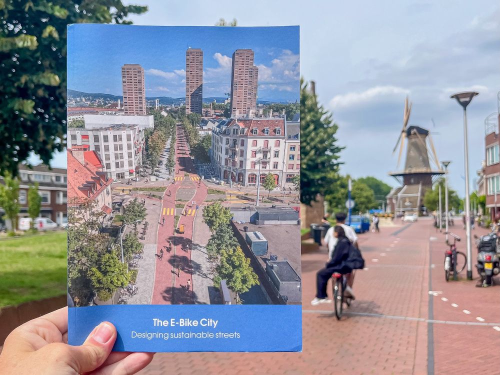 Photographs of the pages of a colourful information booklet about Zurich’s “E-Bike City” project, which proposes reallocating half of its street space to pedestrians, cyclists, and public transport. 