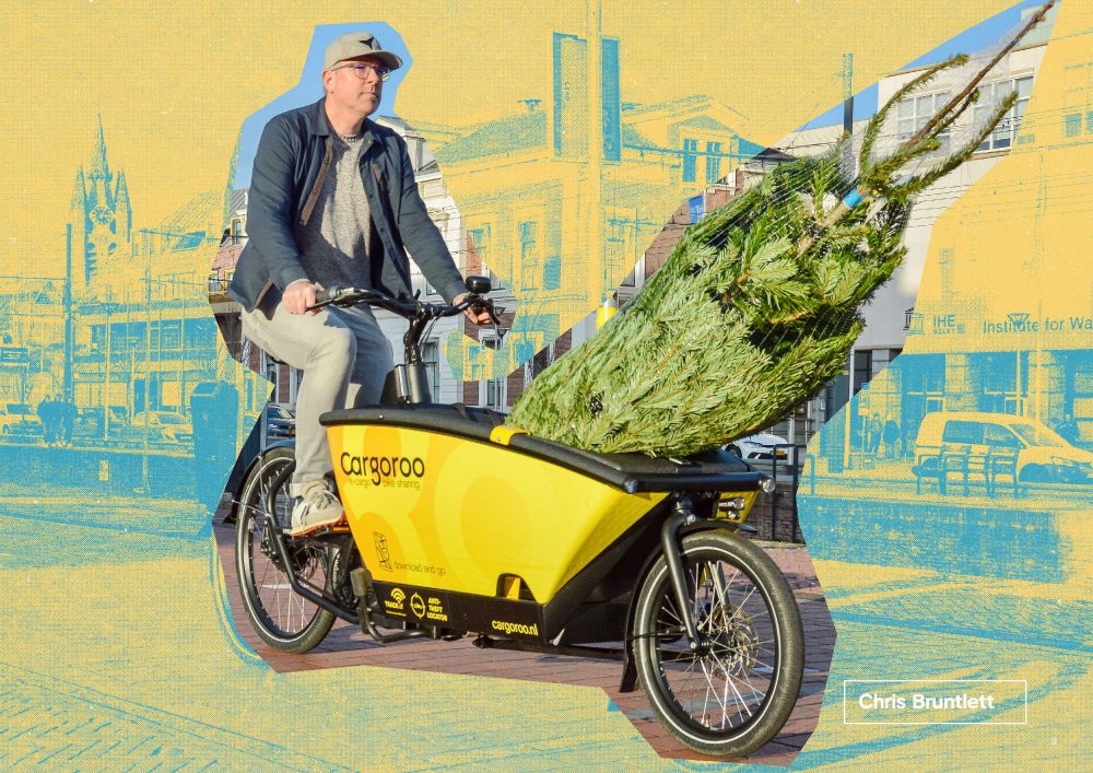 A stylized image of a middle aged man in casual spring attire riding a yellow shared cargo bike with a Christmas tree in the front bucket.