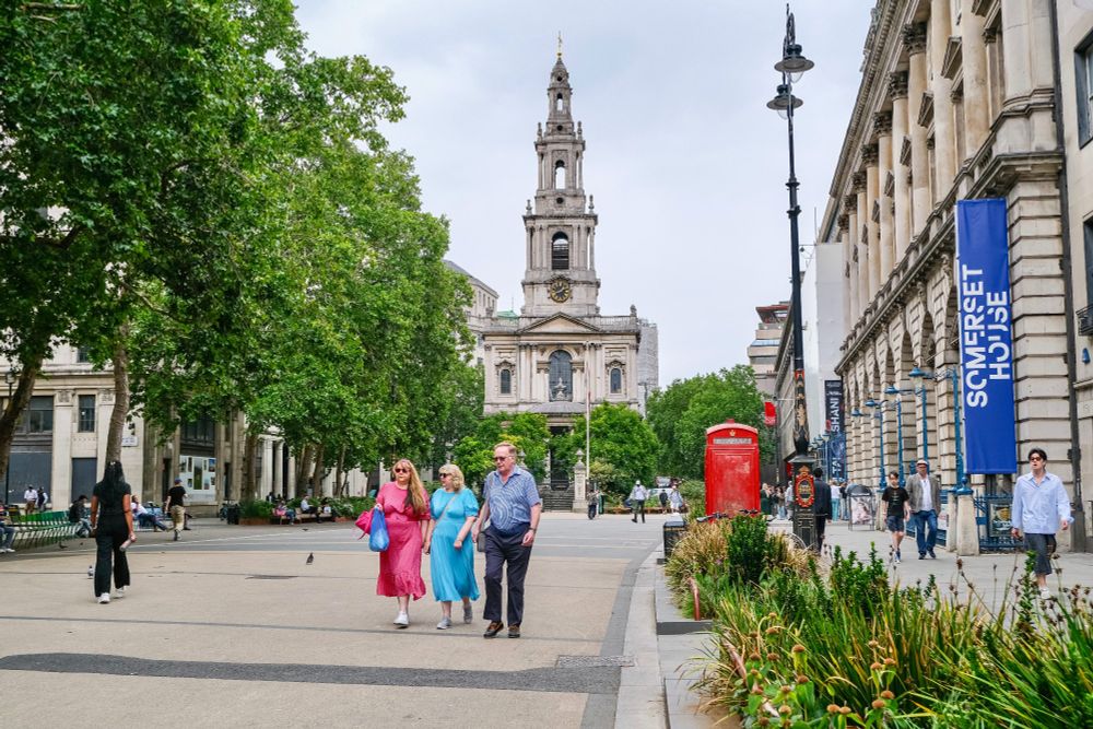 People of all ages and abilities walk, cycle, sit, and socialise on the Strand Aldwych—a former arterial turned pedestrian zone in London, which is lined with buildings, trees, flowers and plantings, benches, and terraces.