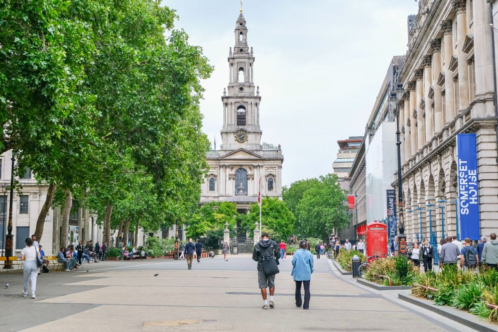 People of all ages and abilities walk, cycle, sit, and socialise on the Strand Aldwych—a former arterial turned pedestrian zone in London, which is lined with buildings, trees, flowers and plantings, benches, and terraces.