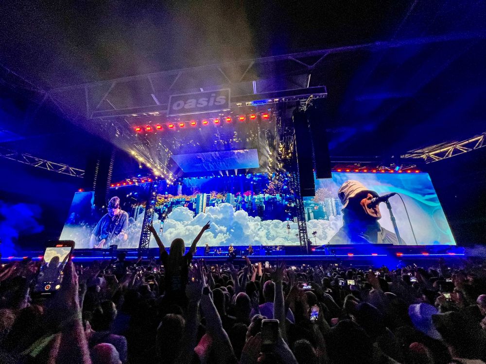Photographs from an concert by British rock band Oasis at Wembley Stadium in London.
