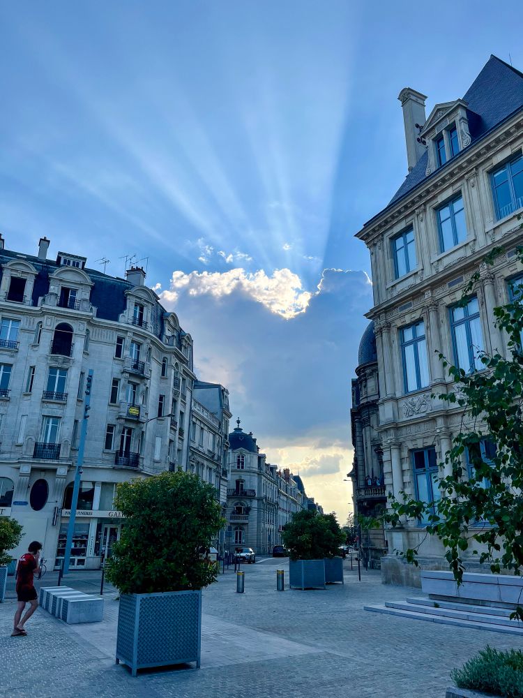 People of all ages and abilities walk, cycle, and dine along the low-traffic streets of Reims, which are lined with buildings, trees, and terraces.