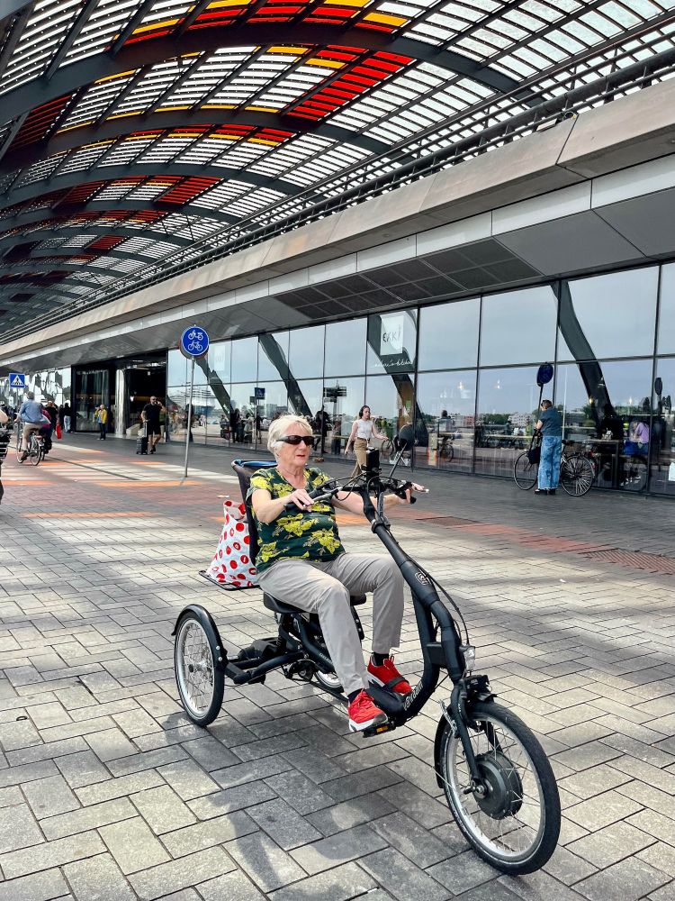 People of all ages and abilities ride tricycles for transportation on the streets of the Netherlands.