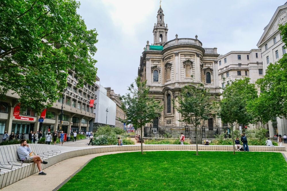 People of all ages and abilities walk, cycle, sit, and socialise on the Strand Aldwych—a former arterial turned pedestrian zone in London, which is lined with buildings, trees, flowers and plantings, benches, and terraces.