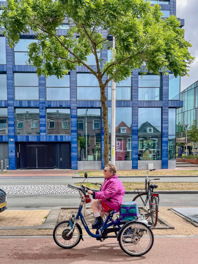 People of all ages and abilities ride tricycles for transportation on the streets of the Netherlands.
