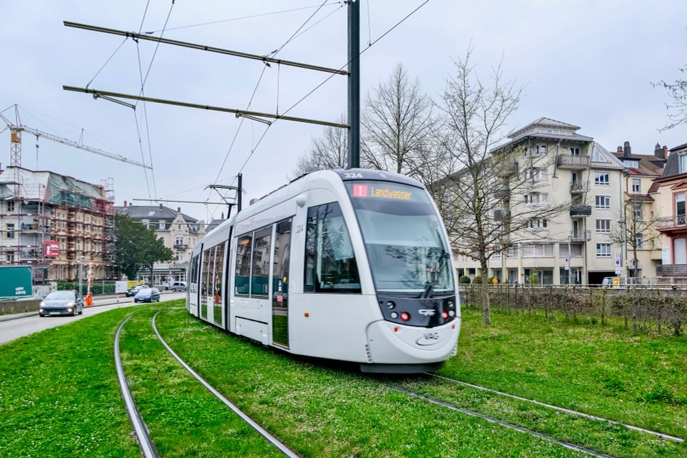 People walk, cycle, and ride trams along the low-traffic streets of Freiburg, Germany.