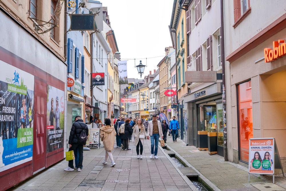 People walk, cycle, and ride trams along the low-traffic streets of Freiburg, Germany.