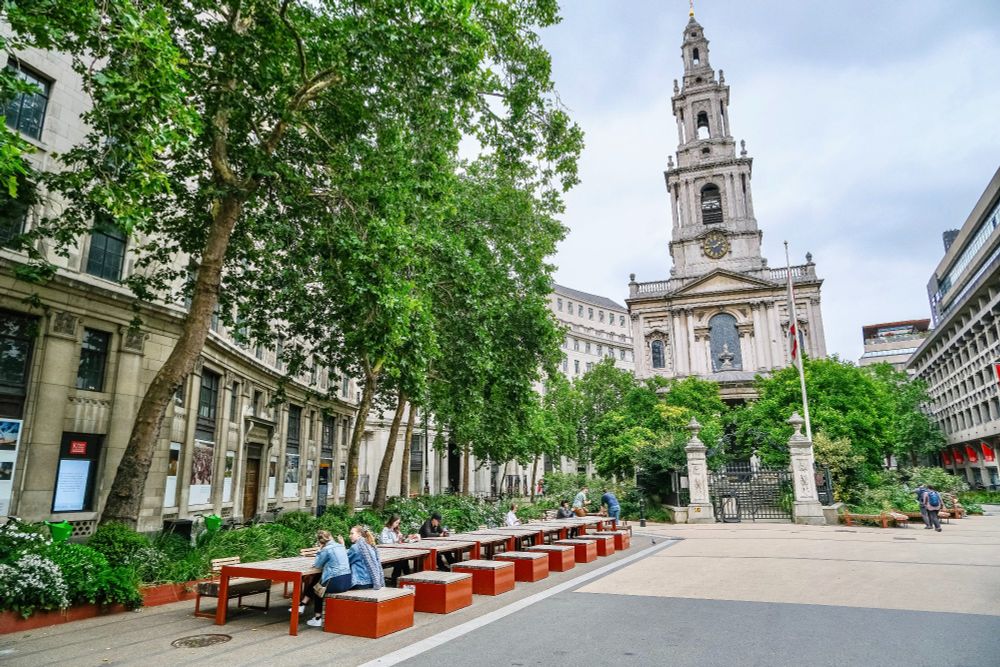 People of all ages and abilities walk, cycle, sit, and socialise on the Strand Aldwych—a former arterial turned pedestrian zone in London, which is lined with buildings, trees, flowers and plantings, benches, and terraces.