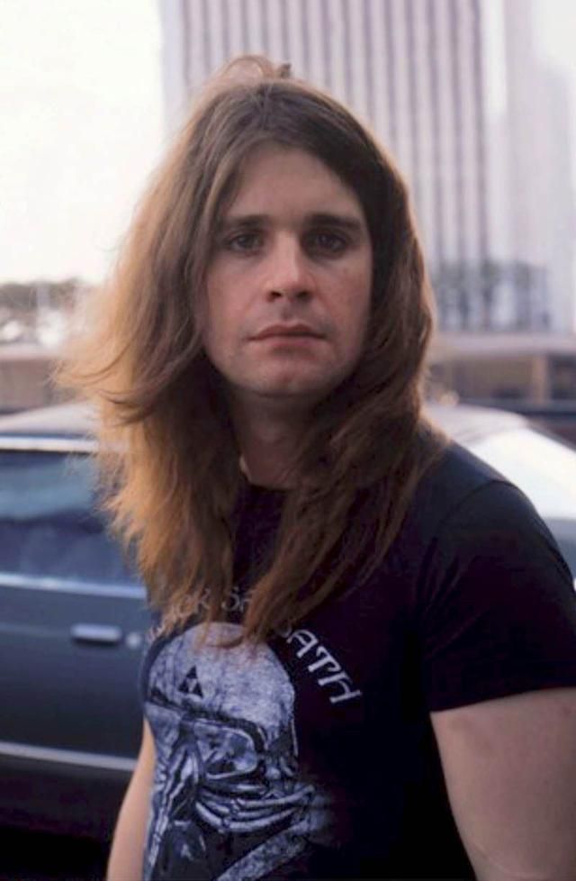 A photograph of a young Ozzy Osbourne, facing and looking right the camera, he has long hair draped down his neck. Facial expression is somewhat serious.