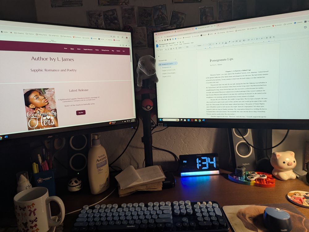 a dual monitor desktop computer setup with a Blue the velociraptor plush in between 