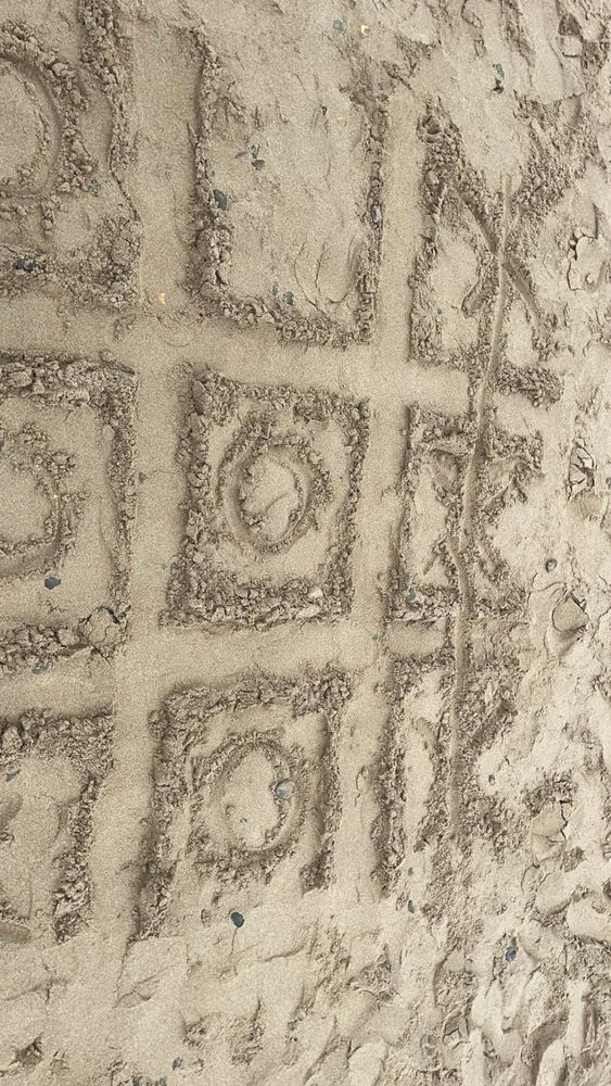 Naughts and Crosses grid drawn in the sand