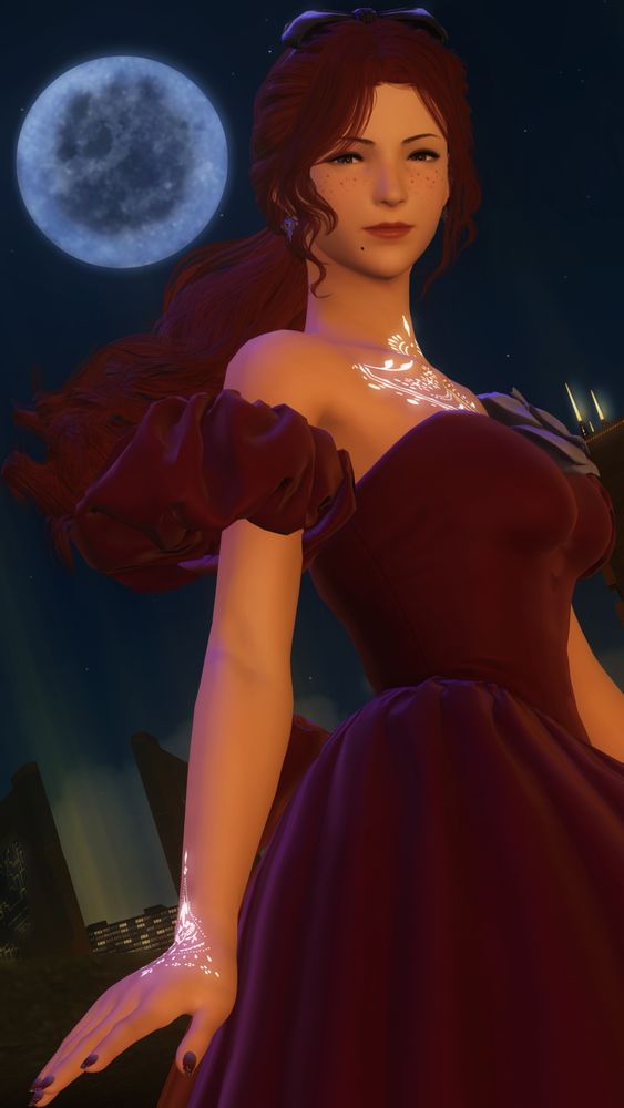 Annabelle, a red-haired Hyur with glowing tattoos, is standing against the night sky with the moon in the background as she smiles at the viewer. She's wearing a red dress with a purple flower on her chest