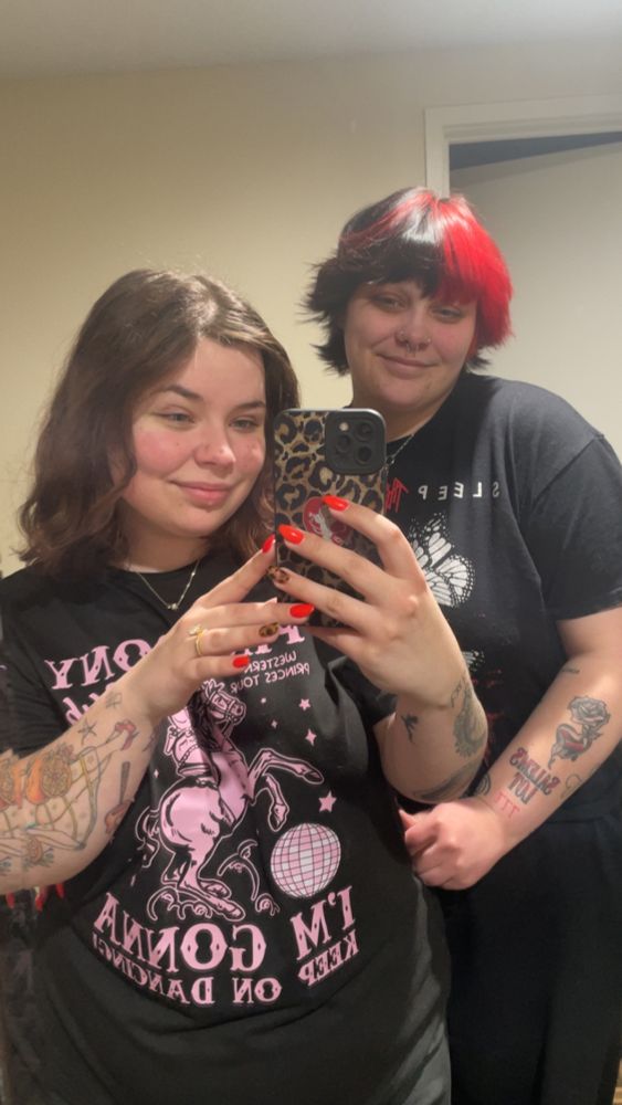 A mirror selfie of my wife and I in our hotel room 12 hours before our nephew was born. We’re both smiling and so excited.