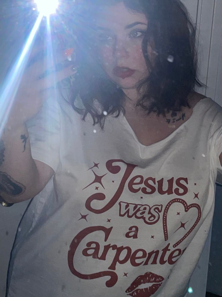 Mirror selfie to show off my shirt saying “Jesus was a carpenter” as in Sabrina Carpenter. 