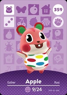 The Animal Crossing amiibo card for Apple. She is a pink hamster with rosy cheeks and a multicolour spotted white tank top. 