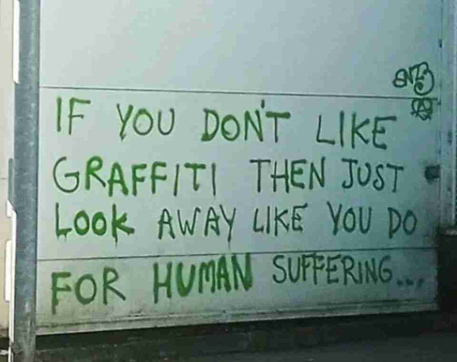 an image of graffiti that reads:
if you don't like graffiti then just look away like you do for human suffering...