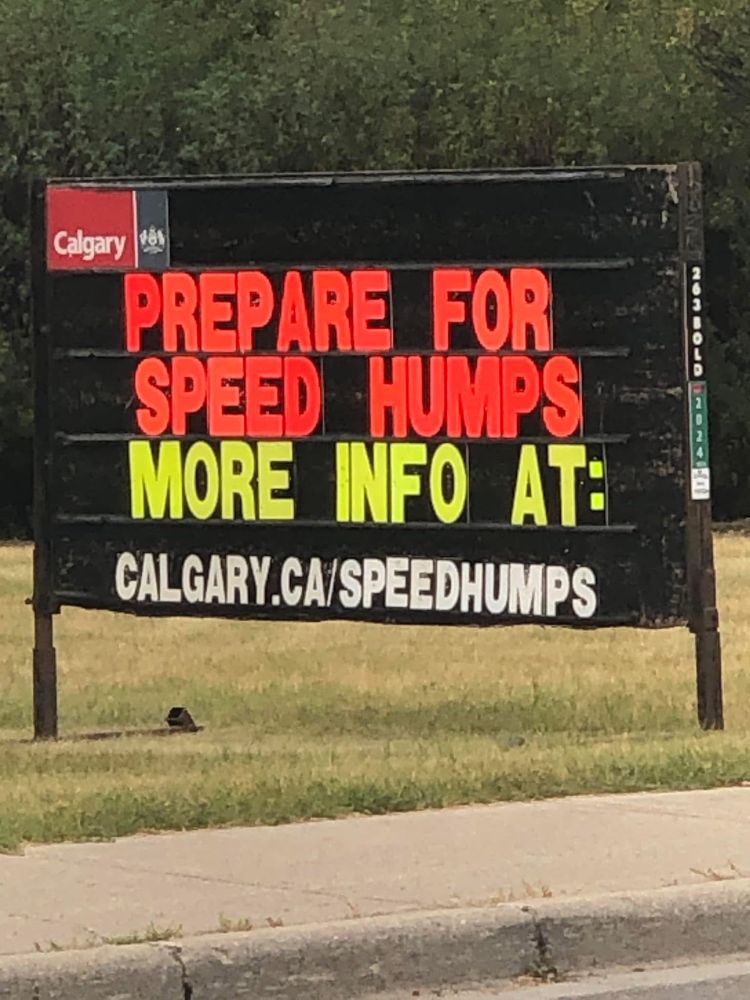 City of Calgary sign that says “prepare for speed humps. More info at Calgary.ca/speedhumps”