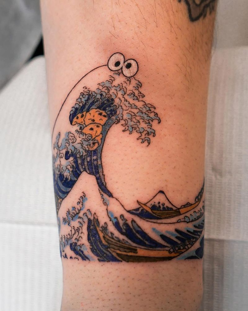 A tattoo of Japanese painting The Great Wave off Kanagawa but made to look like Cookie Monster