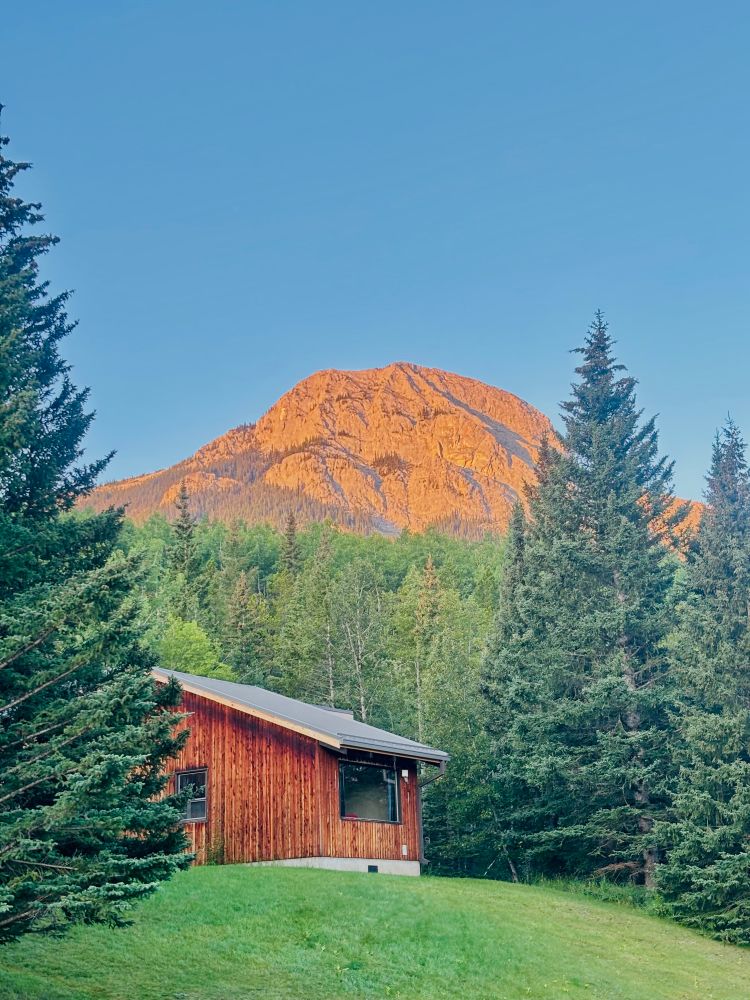 Mountain with a cabin in the first at sunrise