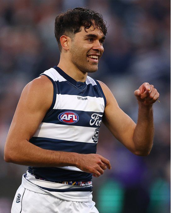 Jack Martin. A footy player in blue and white hooped guernsey while extending his arm in celebration.