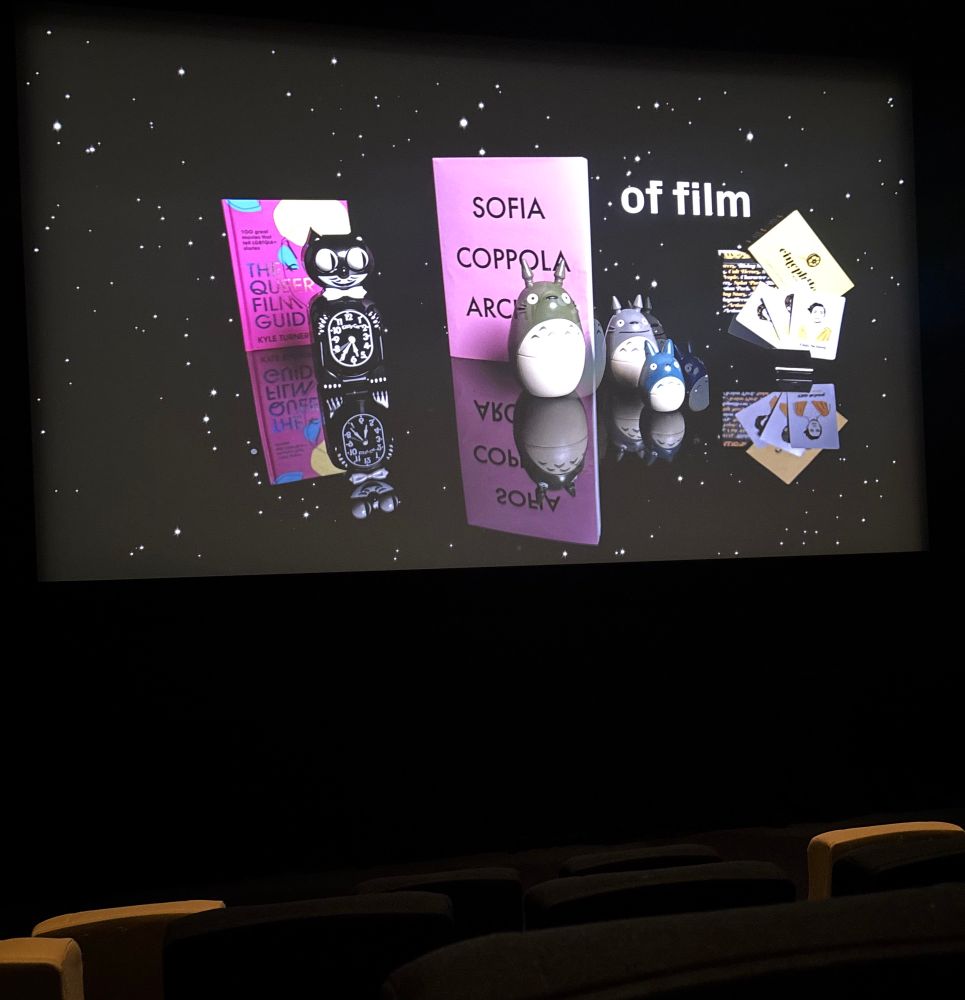 An ad on screen at a cinema showing books and movie memorabilia.