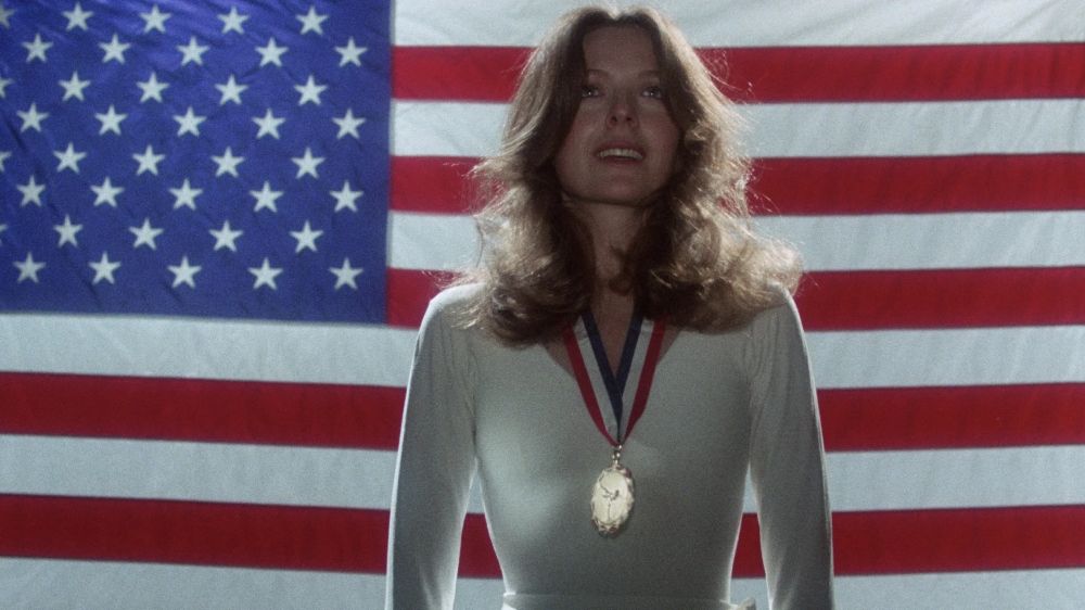 Looking for Mr Goodbar. Diane Keaton stands in front of the American flag with an olympic gold medal around her neck.
