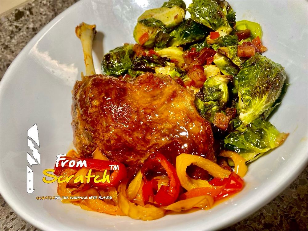 Apricot glazed Crispy Duck leg with roasted Brussels topped with pancetta and a side sautéed sweet bell peppers