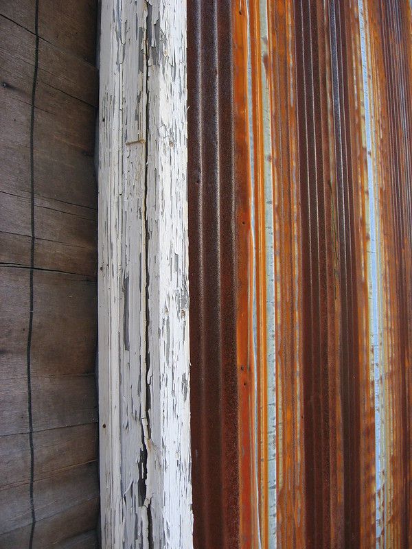 Lines of rust on the side of a building. 