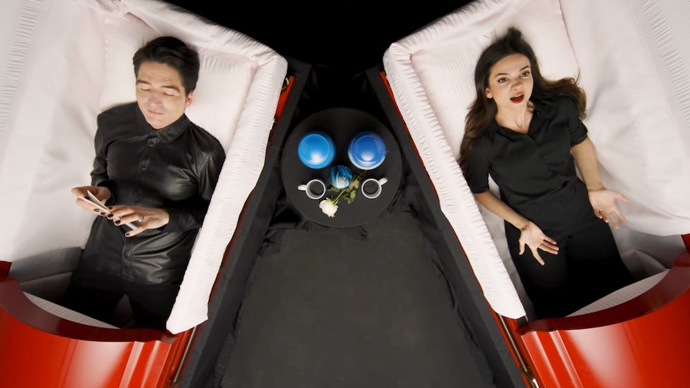 David Dastmalchian and Lauren LaVera discuss their funerals while lying in caskets for Grave Conversations