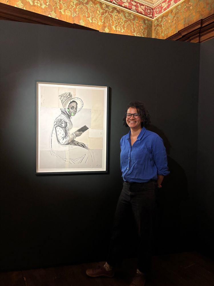 Artist Lela Harris standing next to her portrait of Miss Lambe.