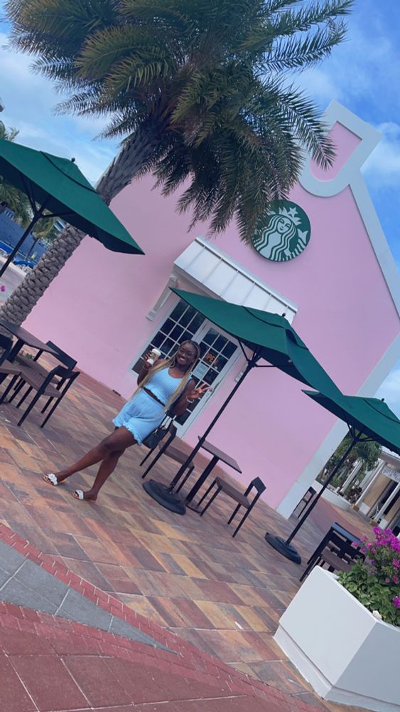 Girl standing in front of a Starbucks coffee shop