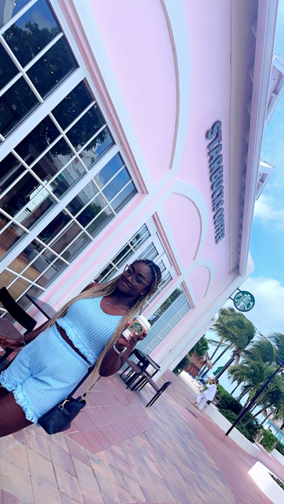 Girl standing in front of a Starbucks coffee shop