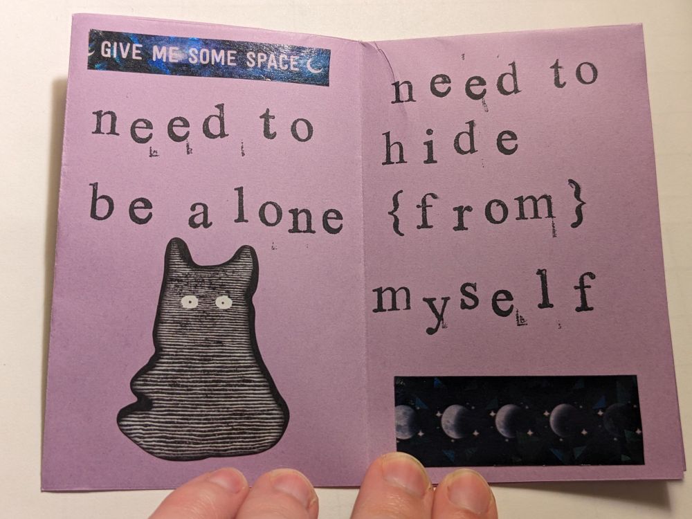 the pages read "need to be alone" and "need to hide {from} myself" in the same stamped lettering as the front cover