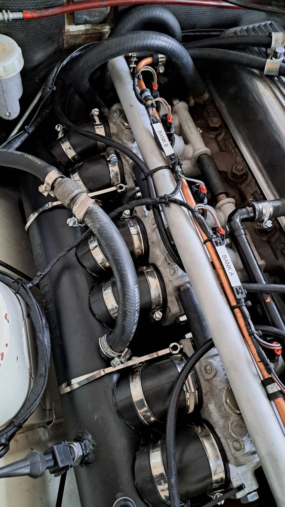Photo showing the reassembled plenum, with stainless steel straps helping secure it to the intake manifold