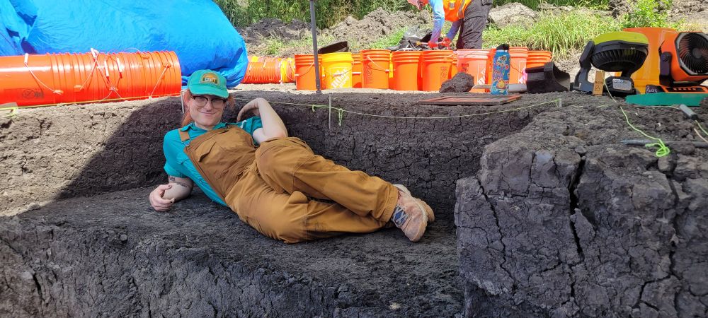 Me laying on my side on a bench that I dug into the side of a pit