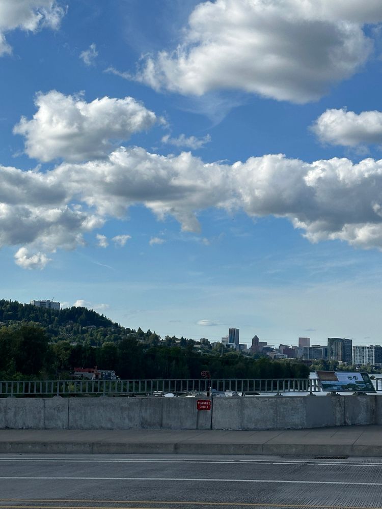 Blue sky, white clouds and a view of south Portland, South Waterfront and part of the downtown skyline looking north from Sellwood Bridge 