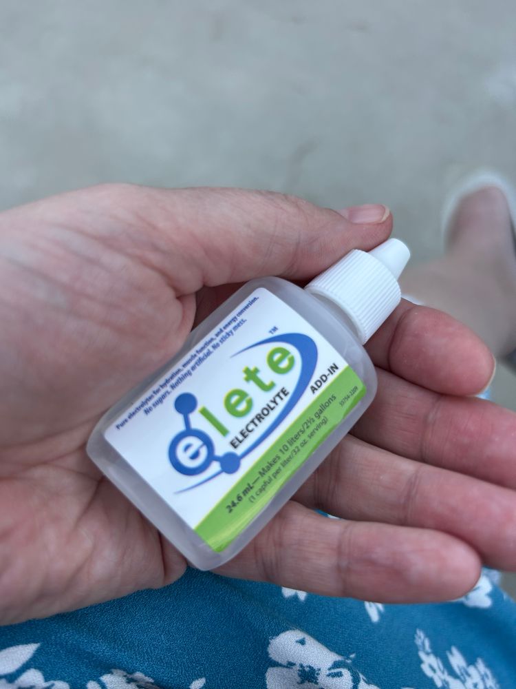 My hand holding Elete electolytes small bottle