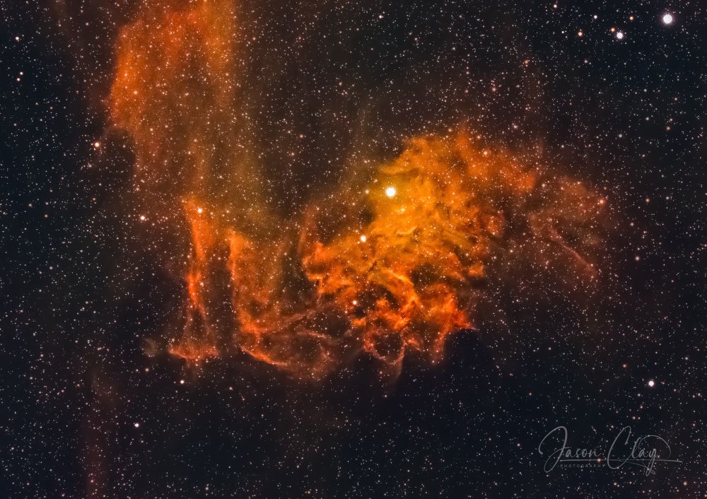 An image of the Flaming Star Nebula, which resembles flames emanating from a star. 