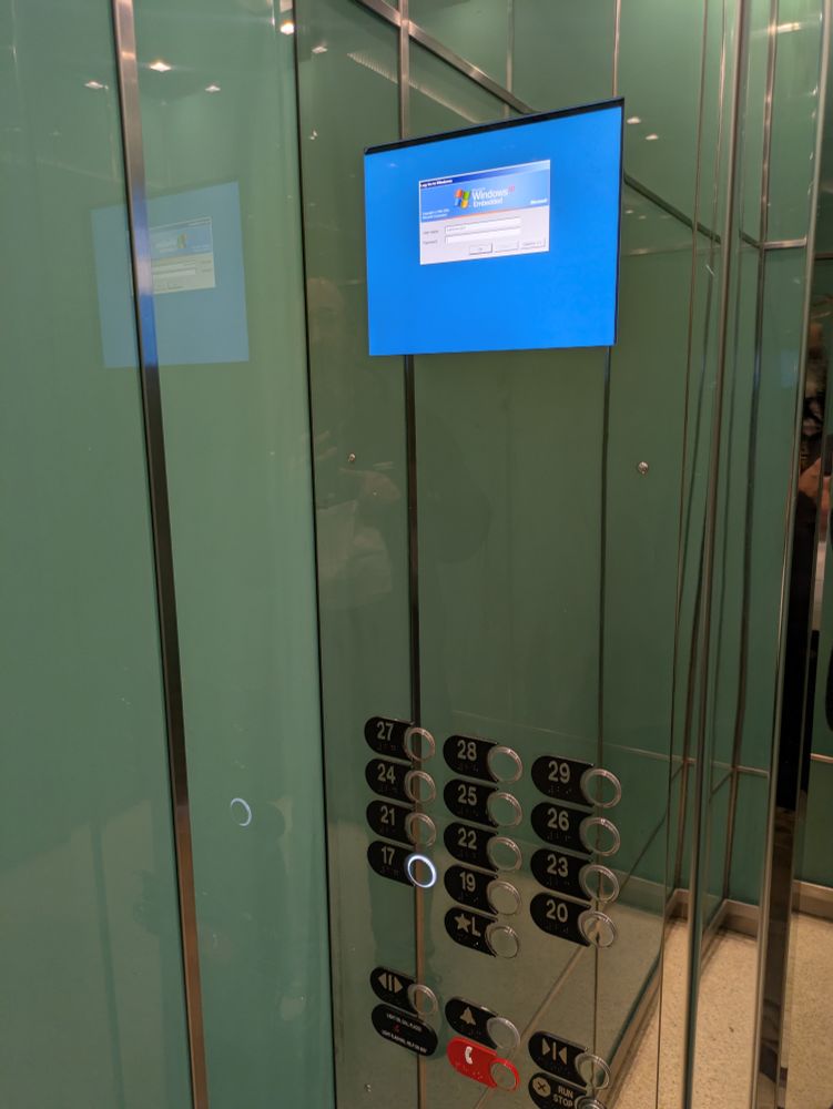 A Windows login dialog box on a small screen in an elevator.