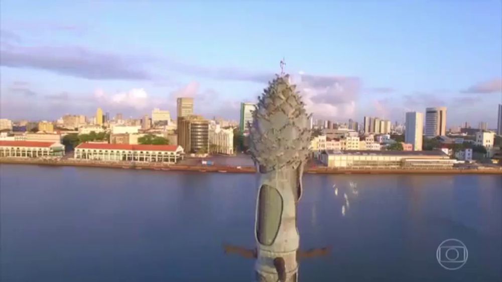 an aerial view of a large body of water with buildings in the background