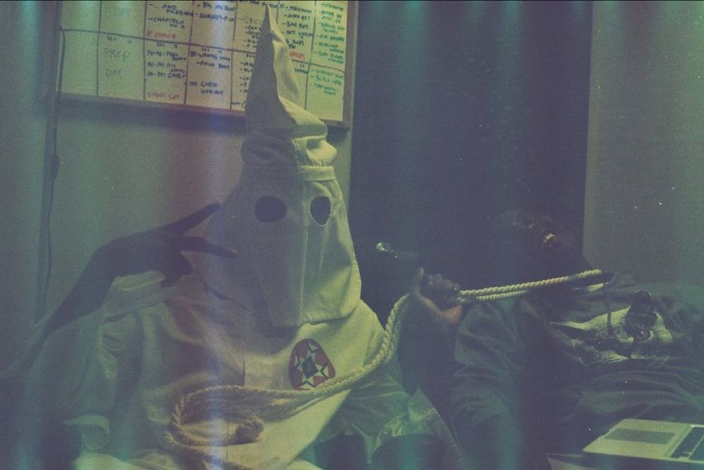 Tyler the creator in klan suit with noose around friends neck