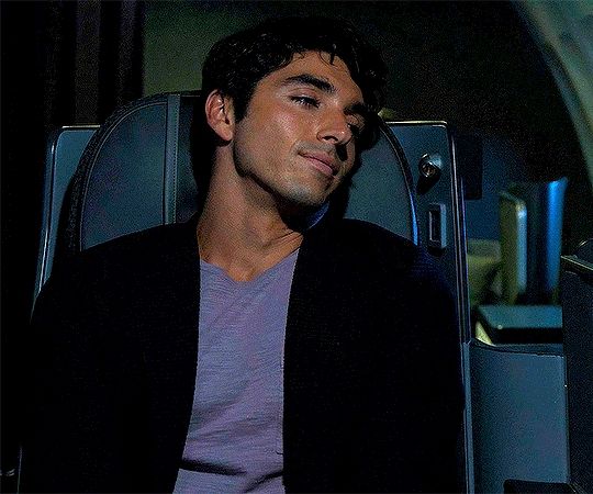 A man sitting on a plane looking out the window