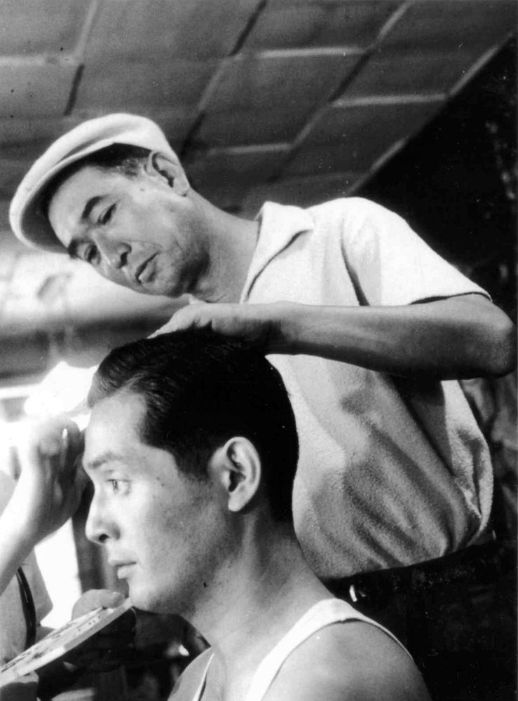 b&w bts still from high and low (1963), kurosawa checking nakadai's hair 📽️