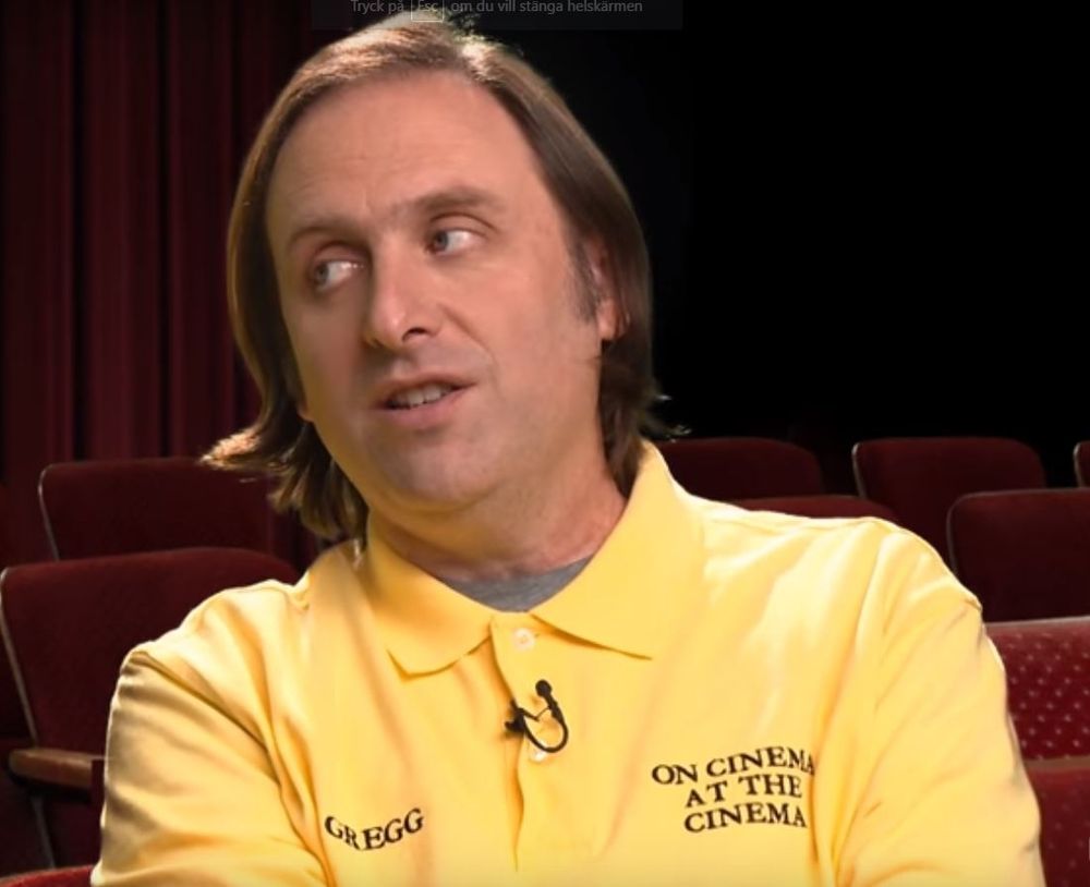 gregg turkington looking over at eric (on bluesky) as he talks