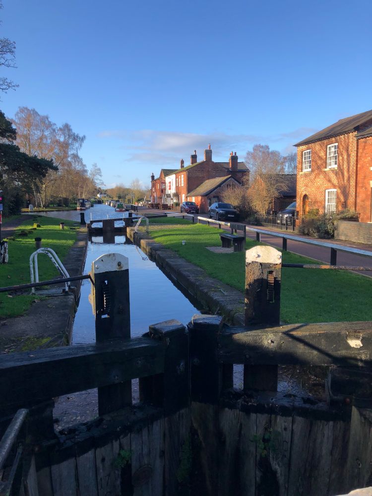 Canal locks with a group of 19th century red brick on the right 