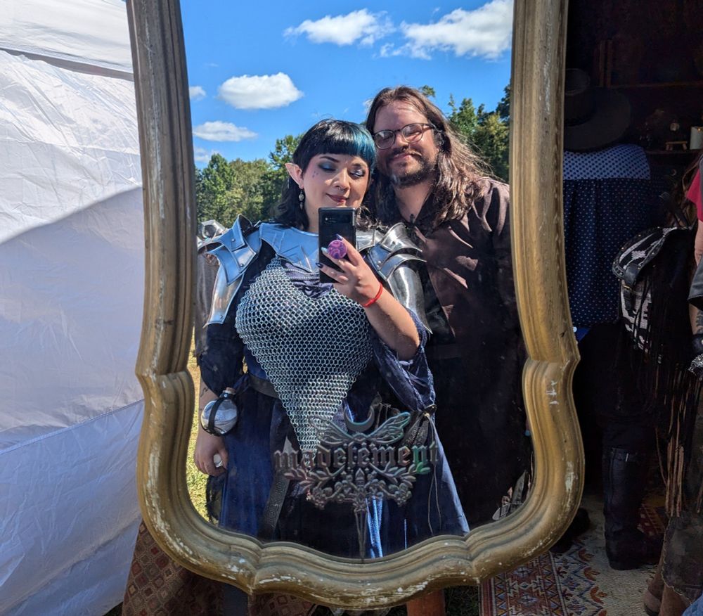 mirror selfie of me wearing armor, standing next to my partner
